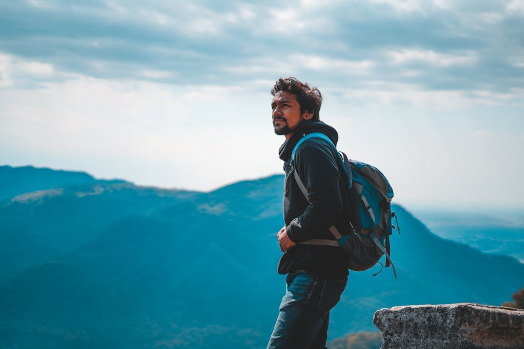 Man Wearing Jacket Carrying A Backpack