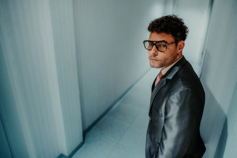 Man in Suit Posing in Corridor